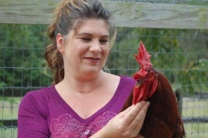 Amy Morgan (above) and a rooster named Roo enjoy a visit on the Morgan’s farm in Rice.
