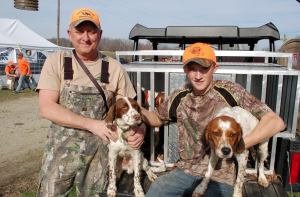 Stewart Godsey, left, and Brad Williamson, of Black Widow and Big Oak Hunt Club in Cartersville, pose with two of the hunting dogs Williamson’s hunt club donated to the hunt.  