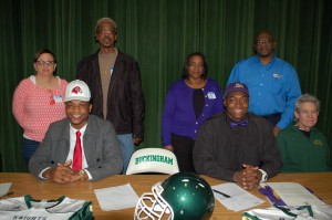 Buckingham’s Leon Ragland singed with Fairmont State University, while Michael Mabry signed with JMU. Pictured are, from left, seated, Ragland, Mabry, BCHS varsity football coach Craig Gill; standing, Rose Gough (guardian), Bradley Gough (guardian), Dianne Mabry (mother) and Michael Mabry (father).