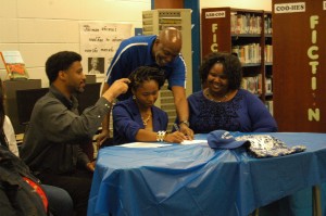 Cumberland’s Ebony Jones signs her letter of intent to St. Andrews University. Pictured are, from left, Darren O. Jones (father), Ebony Jones, St. Andrews track & field coach Charles Stallworth and Tiffany Jones (mother).