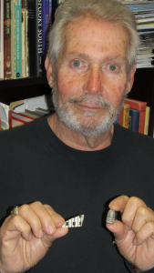 Dr. Jim Jordan holds a fragment of Professor Knauff’s “piano key” dinner plate and a Civil War Minie ball that Dr. Robertson may have removed from a patient.