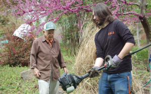 John Gager, 88, left, and Longwood student Michael Campion confer on weed-eating techniques.
