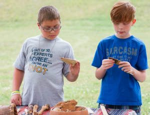 CARSON REEHER From left, Jonathan and Asa Shettle examine some of the tools that Lookofsky brought to share.  