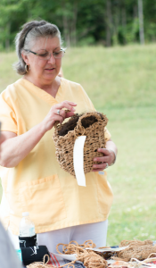 CARSON REEHER Jayne Fanshaw looks at a basket that Lookofsky made using primitive techniques. 