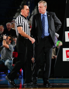 Dr. Ron Bradley, right, confers with a referee during his five years spent as an associate head basketball coach at DePaul University. (Photo by DePaul University)