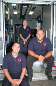JORDAN MILES | HERALD Despite the two-day break the weekend provides, many — including police officers and fire and rescue volunteers — work around the clock seven days a week to care for the community. Pictured, from left, Samuel Bidwell, Kelly Wagner and Bryan McQueen ready themselves for their next rescue call.