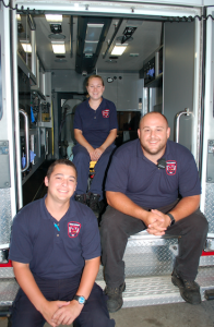 JORDAN MILES | HERALD Despite the two-day break the weekend provides, many — including police officers and fire and rescue volunteers — work around the clock seven days a week to care for the community. Pictured, from left, Samuel Bidwell, Kelly Wagner and Bryan McQueen ready themselves for their next rescue call. 