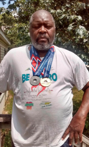 TONI RUSSELL Prince Edward County High School Head Track and Field Coach James Baker wears his medals earned at the 2016 Commonwealth Games in Lynchburg.