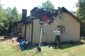 JORDAN MILES | HERALD After striking a tree close to a home at 4878 Darlington Heights Road on Tuesday night, lightning ran along the tree’s roots to the corner of the home.