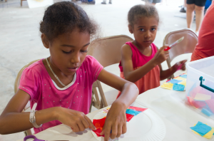 CARSON REEHER | HERALD Zorah Todd, left, and Elianah Todd make crafts in the Kids Corner during Saturday’s farmer’s market.