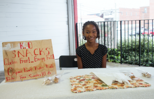 CARSON REEHER | HERALD Kaila Todd sells peanut butter balls in packs of three at her booth. This was her first time selling goods at the farmer’s market.