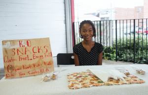 CARSON REEHER | HERALD Kaila Todd sells peanut butter balls in packs of three at her booth. This was her first time selling goods at the farmer’s market. 