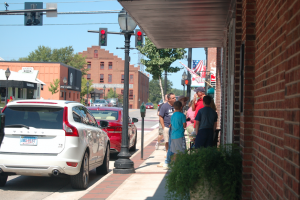 MARTIN L. CAHN | HERALD SHOPPING — A group of people talk outside of one of Main Street’s many shops on Labor Day.