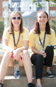 carson reeher | herald From left, Ann Polek and Taylor O’Berry take a break while volunteering with Jubilee festivities. Polek was one of 101 students to watch the debate from inside the Debate Hall. 