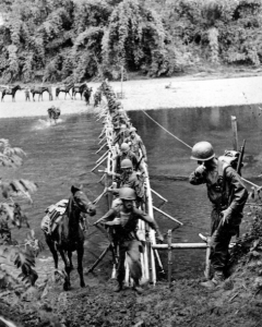 LT. DAVID LUBIN | SIGNAL CORPS On March 18, 1944, men and animals from the 2nd Battalion cross the Tanai River on a bamboo bridge built by Kachin tribesmen, working with the Office of Strategic Services, near the village of Ning Awng.