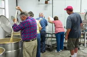 CARSON REEHER | HERALD Ruritan Club members take turn stirring a large batch of stew.