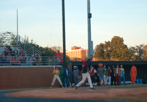 MARTIN L. CAHN | HERALD Deadpool (freshman infielder Antwaun Tucker) hits the ball as his teammates look on.