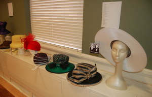 MARTIN L. CAHN | HERALD A selection of the hats for sale — which would also be modeled — during the Rainbow Tea & Hat Sale event Saturday sit in Longwood University’s Blackwell Ballroom. Vellie’s Boutique in Farmville, which sponsored the hat show portion of the event, donated 50 percent of the hats’ sales Saturday to the R.R. Moton Museum.