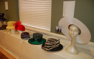 MARTIN L. CAHN | HERALD  A selection of the hats for sale — which would also be modeled — during the Rainbow Tea & Hat Sale event Saturday sit in Longwood University’s Blackwell Ballroom. Vellie’s Boutique in Farmville, which sponsored the hat show portion of the event, donated 50 percent of the hats’ sales Saturday to the R.R. Moton Museum.