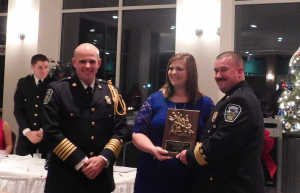 RHONDA FINCH | HERALD Farmville Volunteer Fire Department firefighter Julie Bailey accepts the Most Dedicated Award during the department’s annual banquet at the Farmville Municipal Golf Course on Saturday evening. Presenting her with the award are Chief Andrew Goss, left, and First Assistant Chief Dean Farmer.