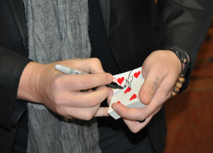 JORDAN MILES | HERALD Crews shuffles cards during a magic trick.