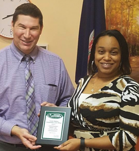Eboni Lee, right, receives the Tucker Watkins Outstanding Local Officer Award from Gore.