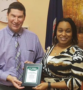 Eboni Lee, right, receives the Tucker Watkins Outstanding Local Officer Award from Gore. 