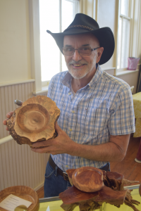 Carter Thomas shows one of his favorite pieces he brought with him to the exhibit.