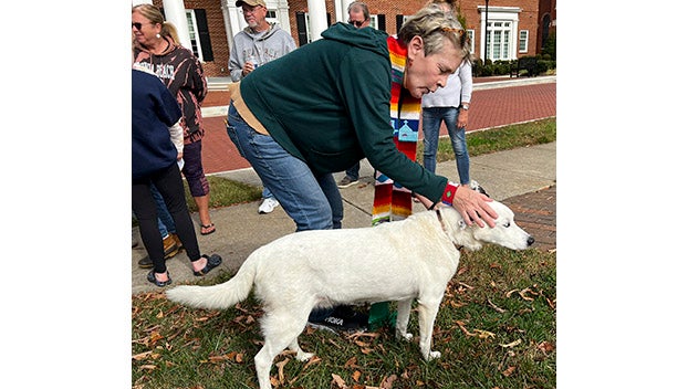 Farmville United Methodist Church’s Rev. Susie Thomas visits with a dog at the blessing of the animals.